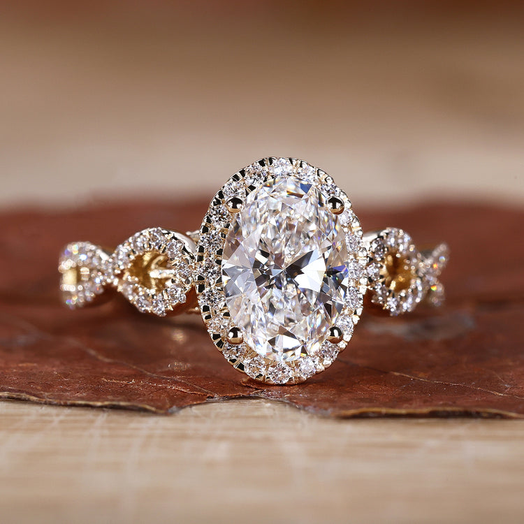 Oval cut engagement ring with prong setting in yellow gold.