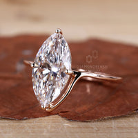 Stunning prong setting ring featuring a marquise diamond in rose gold.