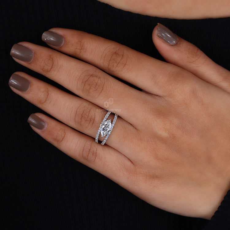 East west marquise engagement ring with round diamonds.