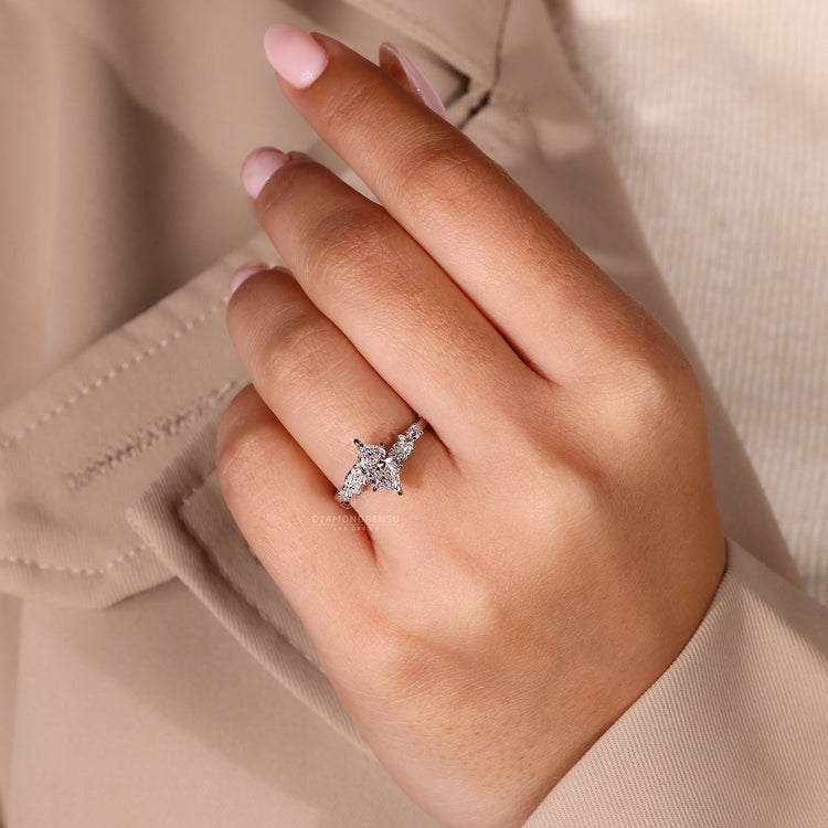 Custom diamond ring with round side stones in a white gold setting.