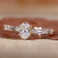 Oval cut diamond ring with baguette and round side stones.