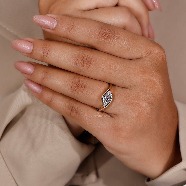 Half bezel engagement ring with a marquise diamond in a classic design
