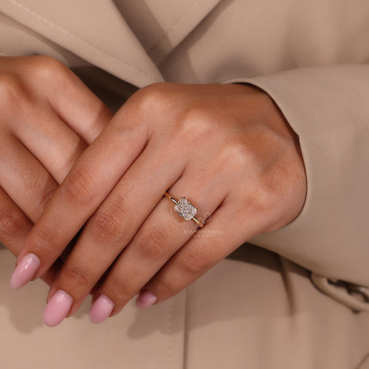 Round diamond halo ring with cushion cut centre in yellow gold.