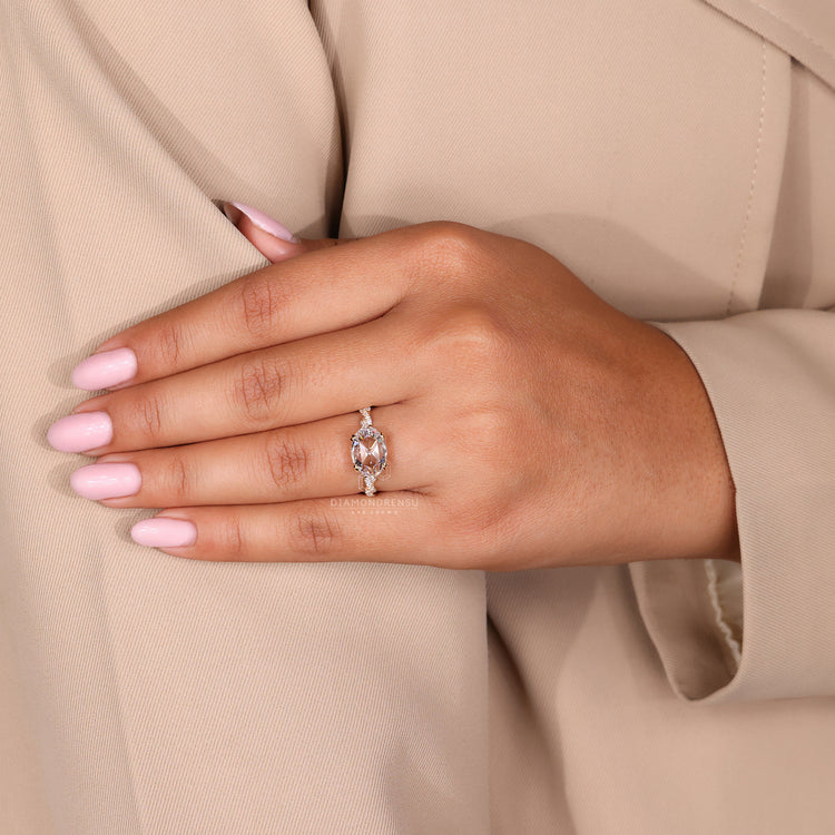 Double claw prong ring holding an oval rose cut diamond.