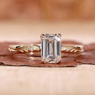 emerald cut diamond ring in yellow gold band.