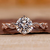 Rose gold diamond ring with round cut diamond and twisted pavé setting.