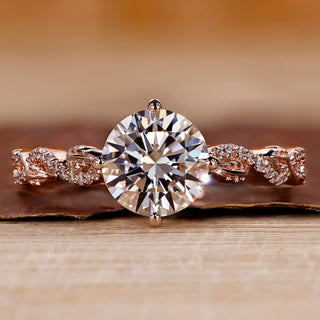 Rose gold diamond ring with round cut diamond and twisted pavé setting.