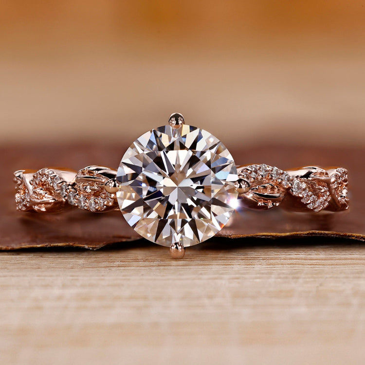Rose gold diamond ring with round cut diamond and twisted pavé setting.