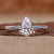 Close-up of a pear shaped diamond ring featuring twisted diamond pave Close-up of a pear shaped diamond ring featuring twisted diamond pave