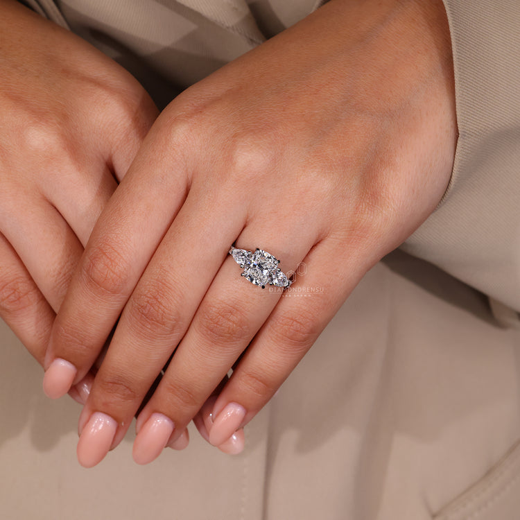 4 claw prong setting holds cushion cut engagement ring.
