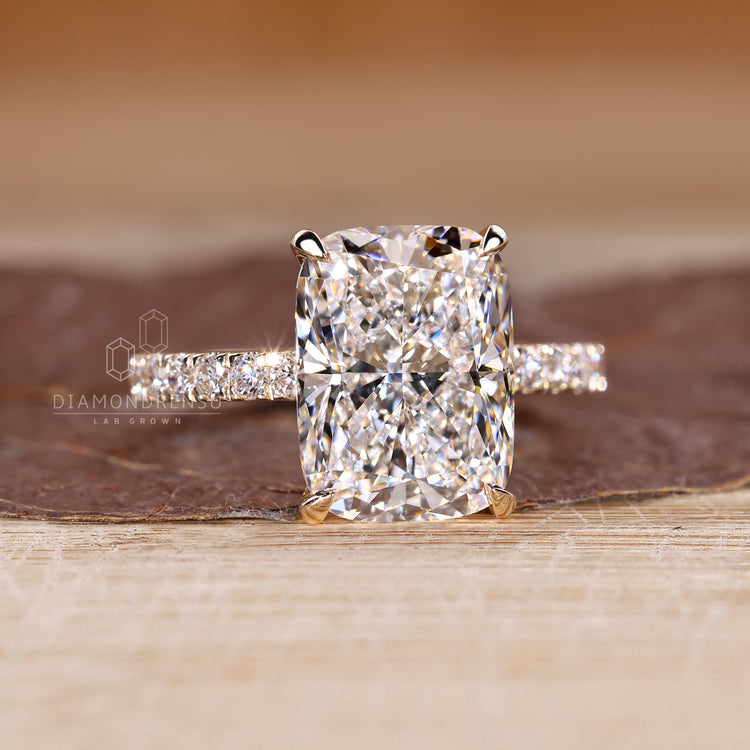 Elongated cushion ring with pave band detail.