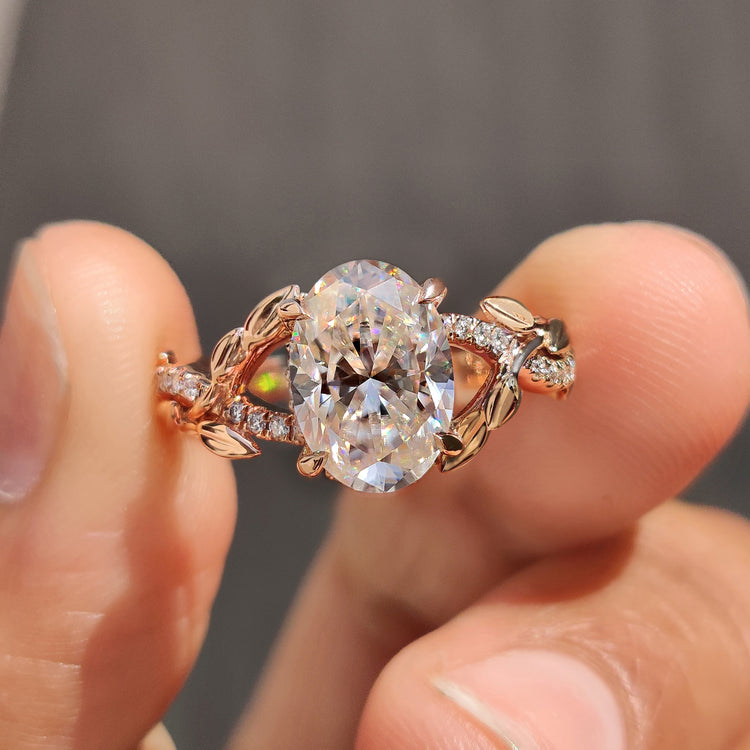 Oval rose gold engagement ring pairs with nature inspired moissanite ring.