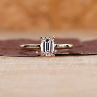 Emerald cut solitaire ring in yellow gold ring.