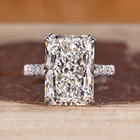 Radiant cut diamond ring with pave round diamond band.