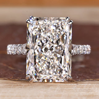 Radiant cut diamond ring with pave round diamond band.