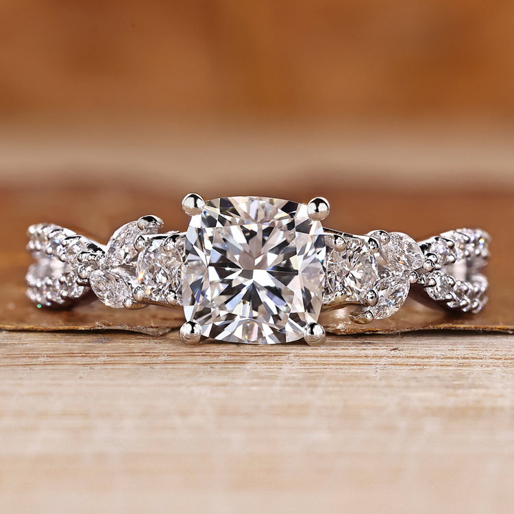 Cushion cut diamond ring marquise and round side stones.