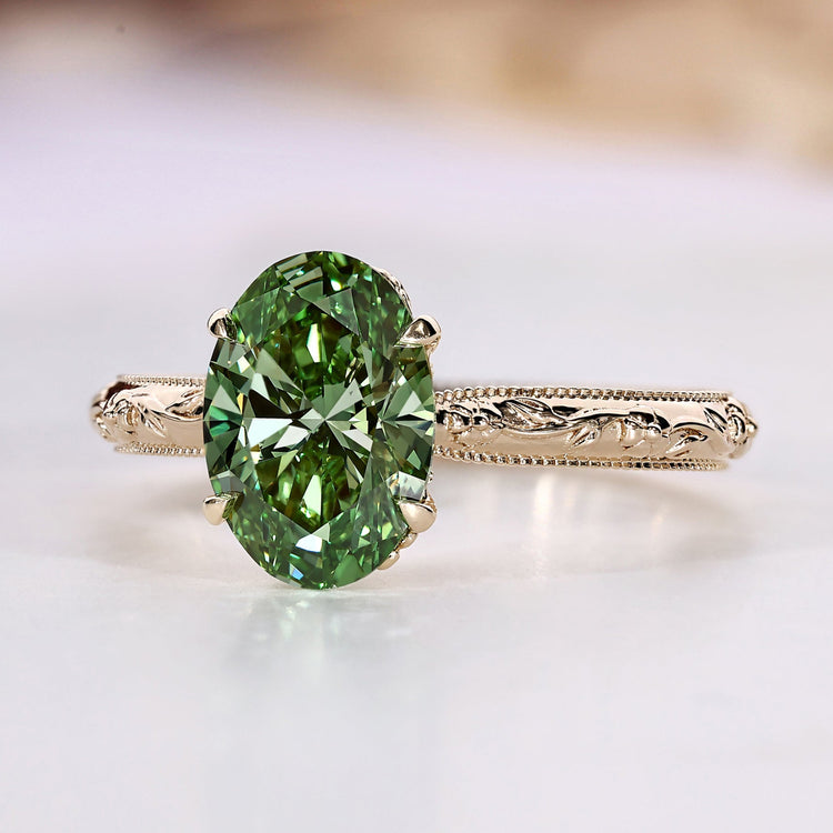Oval cut diamond ring with green diamond.