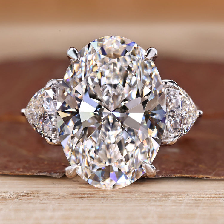 Three stone oval engagement ring with trillion side stones.