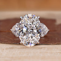 Three stone oval engagement ring with trillion side stones.