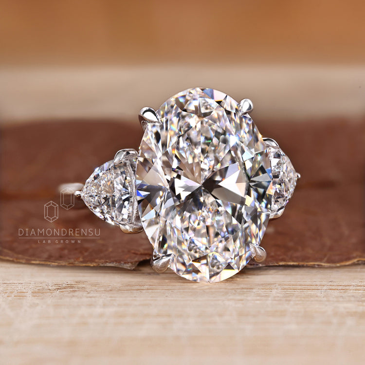 Cathedral setting ring with oval diamond and trillion stones.