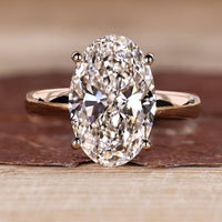 Oval cut diamond ring with hidden halo engagement design.