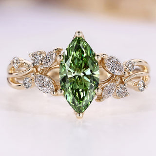 Green diamond ring with round and marquise side stones.