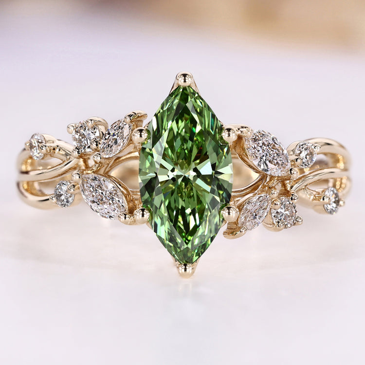 Green diamond ring with round and marquise side stones.