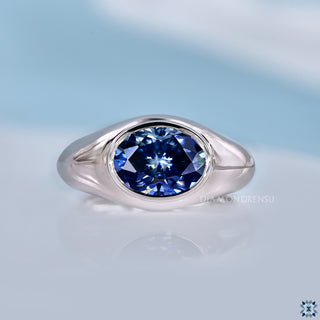Oval moissanite ring with blue centre stone in solitaire style.