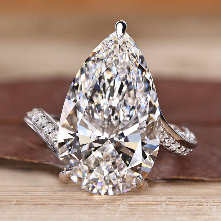 Pear cut diamond ring with double row pave band.