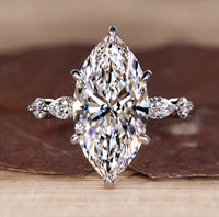5 stone diamond ring with marquise centre and round side stones.