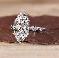 Custom diamond ring featuring marquise and round side stones.