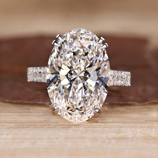 Oval diamond engagement ring with double row pave band.
