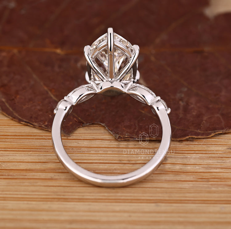 Marquise diamond ring with pave and six claw prong setting.
