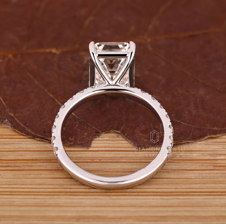 Diamondrensu AU ring with emerald cut diamond and pave setting.