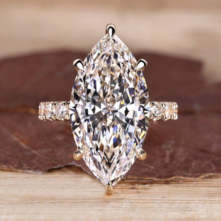 Marquise diamond ring with hidden halo engagement design.