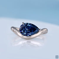 pear cut moissanite ring in solitaire style with east to west setting.