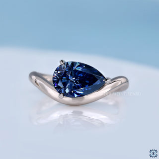 pear cut moissanite ring in solitaire style with east to west setting.