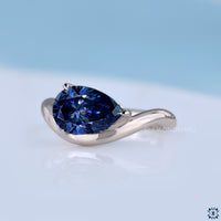 Handmade pear cut moissanite ring with sleek gypsy setting.