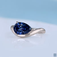 Handmade pear cut moissanite ring with sleek gypsy setting.