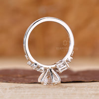 Unique emerald and round cut side stones ring.