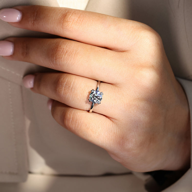 Simple white gold engagement ring with brilliant round diamond.