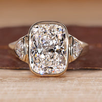 Cushion Cut Diamond Ring with trillion side stones.