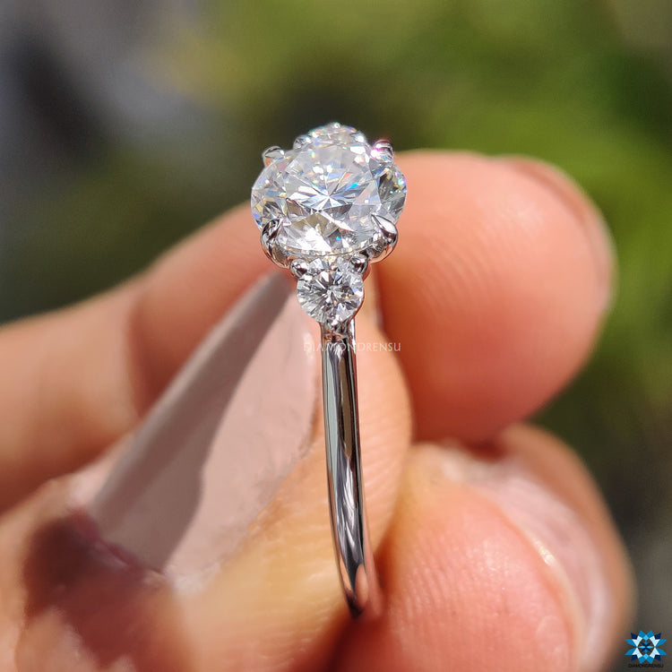 Round moissanite ring four claw prong setting.