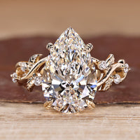 Pear Cut Diamond Ring with round side stones.