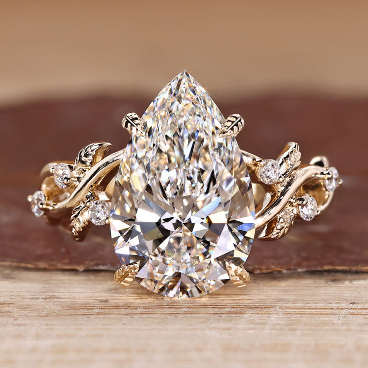 Pear Cut Diamond Ring with round side stones.
