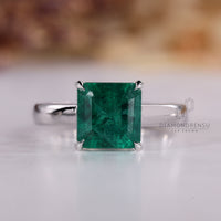 Asscher cut emerald ring solitaire cathedral prong set.