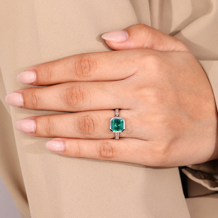 Asscher gemstone ring emerald channel diamond band.