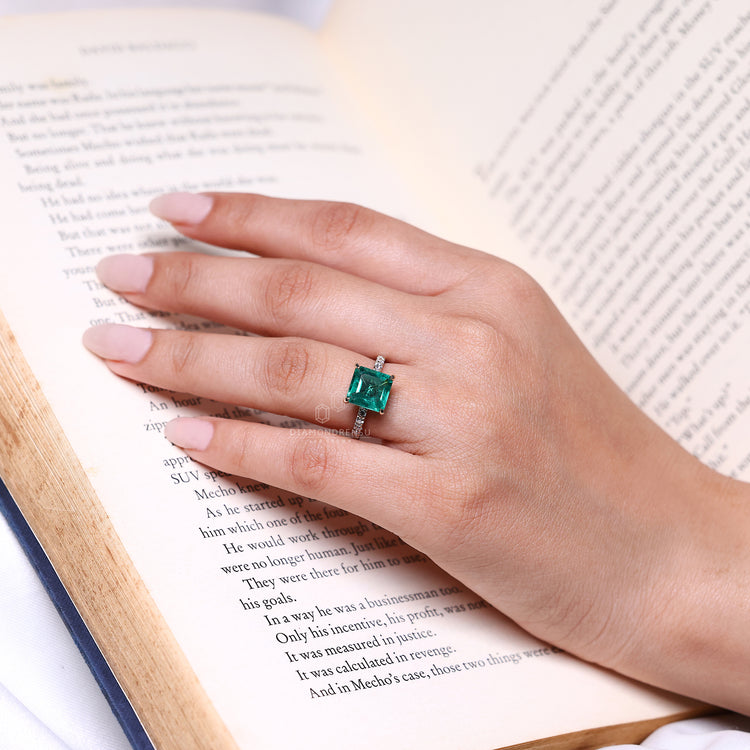 Asscher cut ring emerald pave four claw prong setting.