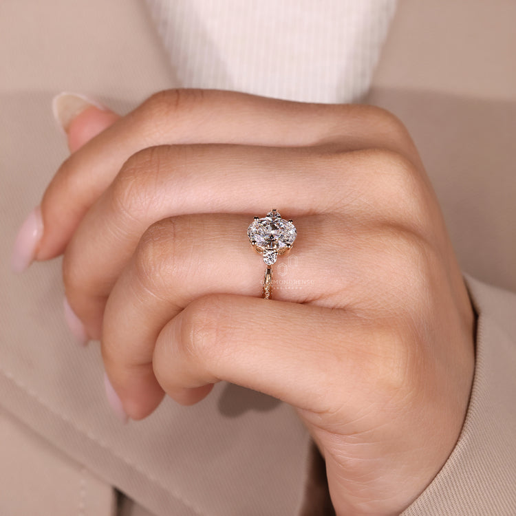 Oval cut diamond ring four prong tapered shank style.