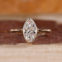Marquise diamond ring solitaire bezel setting pinch shank.